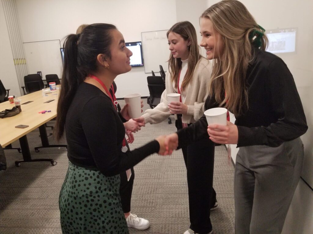 student shaking hands with a mentor